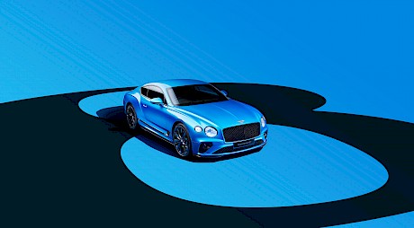 Sleek Bentley car shot on a blue and black circular graphic background in the studio by photographer Wilson Hennessy represented by top London agents Horton-Stephens.