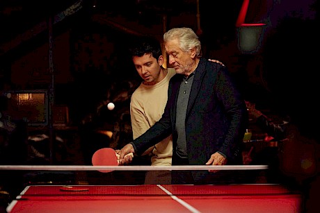 Asa Butterfield teaches Robert De Niro to play ping pong captured alongside motion by fab photographer Marco Mori represented by London's top photo agency Horton-Stephens