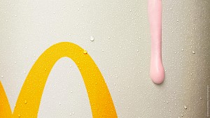 close up of pink strawberry milkshake drip on McDonalds cup photographed by top London food photographer Chelsea Bloxsome represented by best London Photo Agency Horton-Stephens