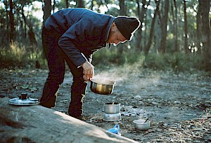 This colour photo shows outside cooking by James Bowden, UK  photographer, represented by Horton-Stephens photographer’s agents specialises in natural and authentic  lifestyle outdoors nature photographic images.