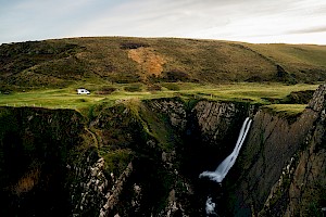 This colour photo shows cliff landscape with waterfall by James Bowden, UK  photographer, represented by Horton-Stephens photographer’s agents specialises in natural and authentic  lifestyle outdoors nature photographic images.