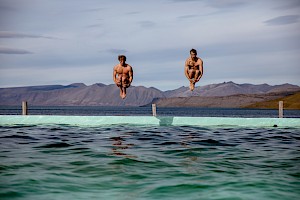 This colour photo shows mountains lake swimming by James Bowden, UK  photographer, represented by Horton-Stephens photographer’s agents specialises in natural and authentic  lifestyle outdoors nature photographic images.