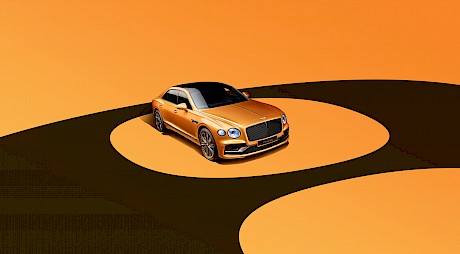 Sleek Bentley car shot on a yellow circular graphic background in the studio by photographer Wilson Hennessy represented by top London agents Horton-Stephens.