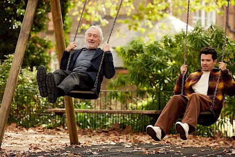Robert De Niro and Asa Butterfield shot swinging in playground by top photographer Marco Mori represented by London agency Horton-Stephens