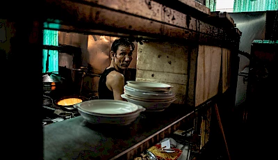 man in the kitchen in hong kong shot by Florian Geiss top London photographer with Horton-Stephens photo agency