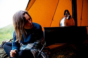 This colour photo shows a cooking camp scene by James Bowden, UK  photographer, represented by Horton-Stephens photographer’s agents specialises in natural and authentic  lifestyle outdoors nature photographic images.